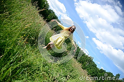 Happy woman dancing on the grass Stock Photo