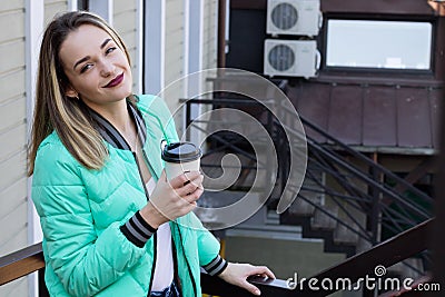 Happy Woman Drinking Coffee in the City Stock Photo