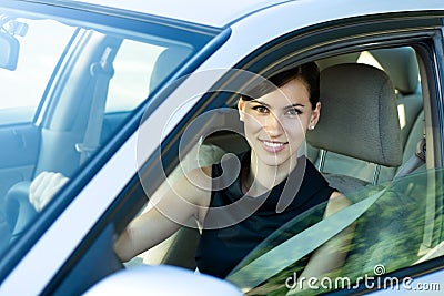 Happy woman driving the car Stock Photo