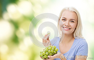 Happy woman eating grapes Stock Photo