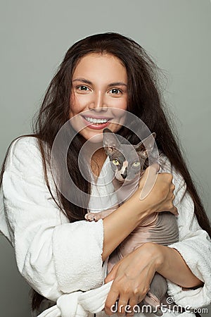Happy woman embracing sphinx cat Stock Photo