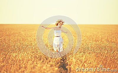 Happy woman enjoying life in golden wheat field Stock Photo