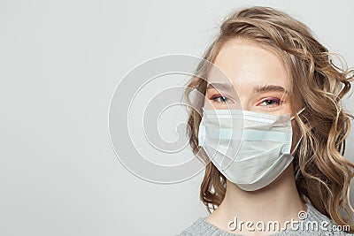 Happy woman in face mask on white background, female face close up Stock Photo