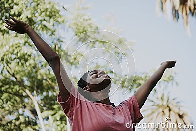 Happy woman feeling free in the park Stock Photo