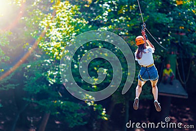 Woman wears protective helmet enjoy active leisure in rope park Stock Photo