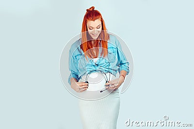 Happy woman giving music to baby in belly Stock Photo