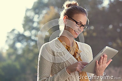 Happy woman in glasses using tablet pc Stock Photo