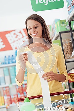 Happy woman with grocery receipt Stock Photo