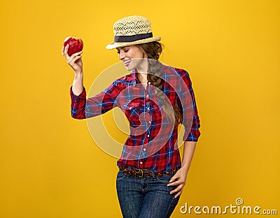 Happy woman grower isolated on yellow posing with an apple Stock Photo