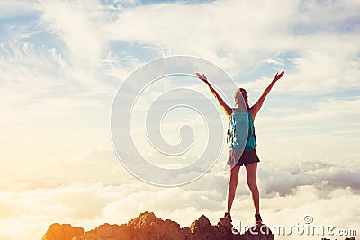 Happy Woman Hiker With Open Arms at Sunset on Mountain Peak Stock Photo