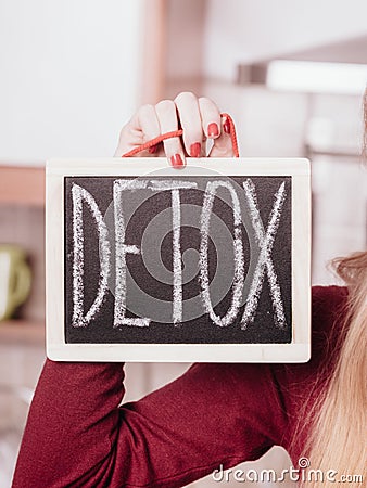 Happy woman holding board with detox sign Stock Photo