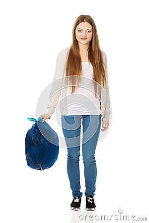 Happy woman holding a full garbage bag. Stock Photo