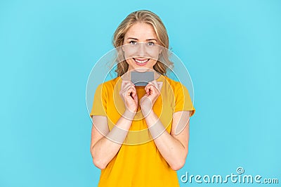 Happy woman holding plastic credit card in her hands Stock Photo