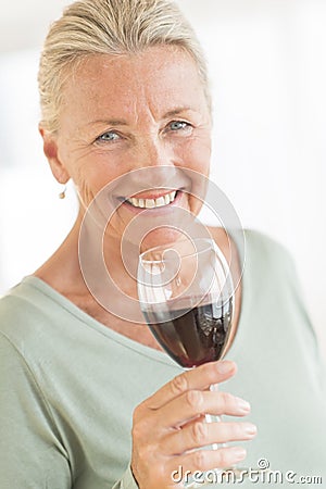 Happy Woman Holding Wineglass At Home Stock Photo