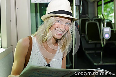 happy woman on holidays reading on bus Stock Photo