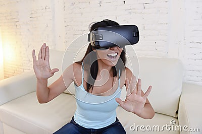 Happy woman at home living room sofa couch excited using 3d goggles watching 360 virtual reality Stock Photo