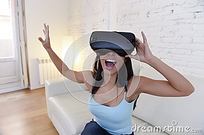 Happy woman at home living room sofa couch excited using 3d goggles watching 360 virtual reality Stock Photo