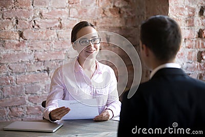 Happy woman hr manager with resume looking at job seeker. Stock Photo