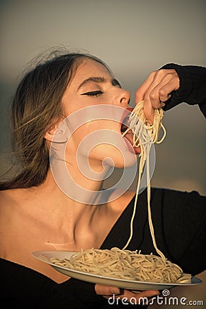 Happy woman. Hunger, appetite, recipe. Diet and healthy organic food, italy. Woman eating pasta as taster or restaurant Stock Photo