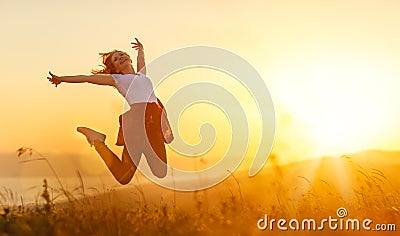 Happy woman jump, rejoices, on sunset in nature Stock Photo