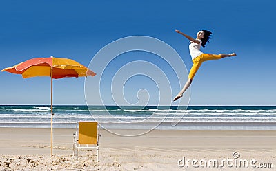 Happy woman jumping at beach Stock Photo