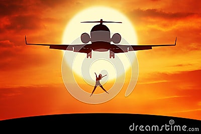 Happy woman leaps on the hill under airplane Stock Photo