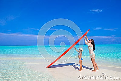 Happy woman and little girl at white beach with Stock Photo