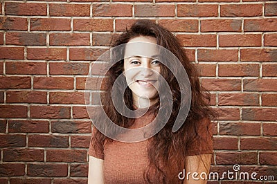 Happy woman with long lush hair. full of happiness. cheerful girl on brick wall background Stock Photo