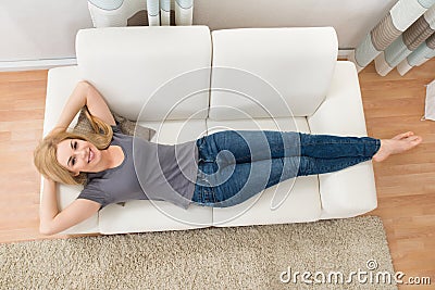 Happy Woman Lying On Sofa Stock Photo