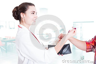 Happy woman medic accepting bribery Stock Photo