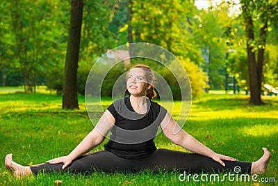 happy woman oversize flexible stretched on a lawn sitting Stock Photo