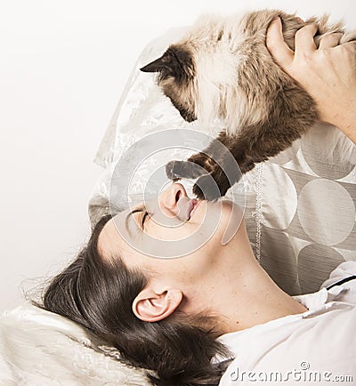Happy woman playing with cat Stock Photo