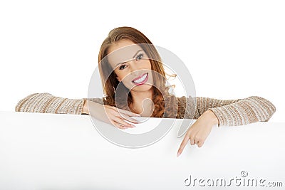 Happy woman pointing on blank board. Stock Photo