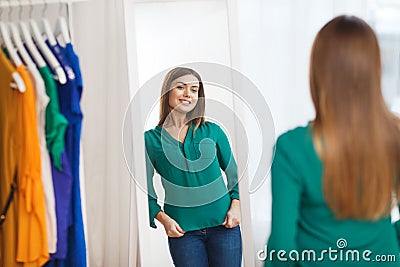 Happy woman posing at mirror in home wardrobe Stock Photo