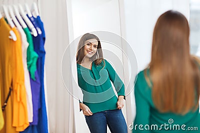 Happy woman posing at mirror in home wardrobe Stock Photo