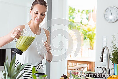 Woman pouring cocktail into jar Stock Photo