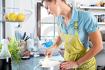 Happy woman preparing heartshape cake Stock Photo