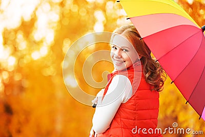 Happy woman with rainbow multicolored umbrella under rain in par Stock Photo