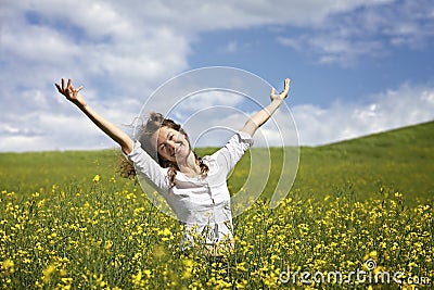 Happy woman in rapeseed field Stock Photo