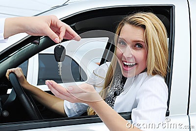 Happy woman receiving car key Stock Photo