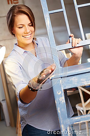 Happy woman renewing chair Stock Photo