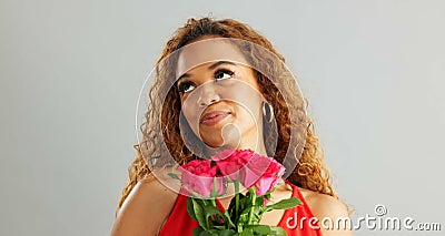 Happy woman, roses and valentines day with flowers for love, care or romance on a gray studio background. Portrait of Stock Photo