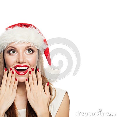 Happy woman in Santa hat with red manicure nails near red lips isolated. Surprised Christmas girl looking up Stock Photo