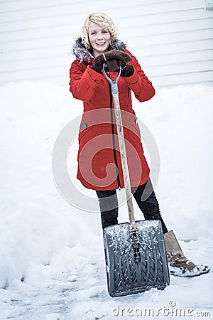 Happy Woman with a Shovel in a Parking lot Stock Photo