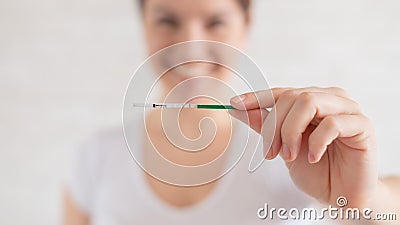 Happy woman shows a positive pregnancy test. The concept of female fertility. Human chorionic gonadotropin. Two stripes Stock Photo