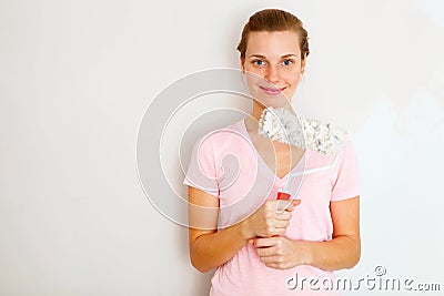 Happy Woman standing againtst wall Stock Photo