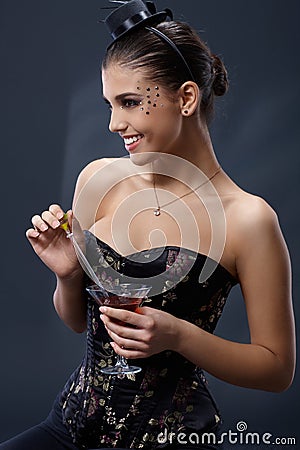 Happy woman stirring cocktail Stock Photo