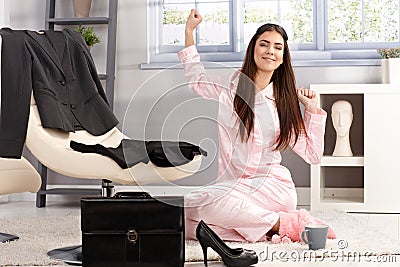 Happy woman stretching in pyjama Stock Photo