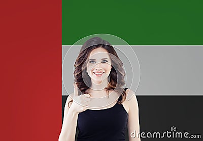 Happy woman student with thumb up on the UAE flag background. United Arab Emirates, travel and learn arabic language concept Stock Photo
