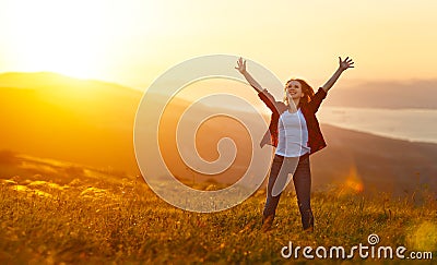 Happy woman on sunset in nature iwith open hands Stock Photo